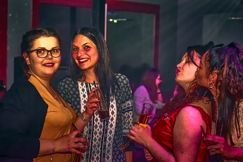 Friends enjoying drinks and conversation at a party